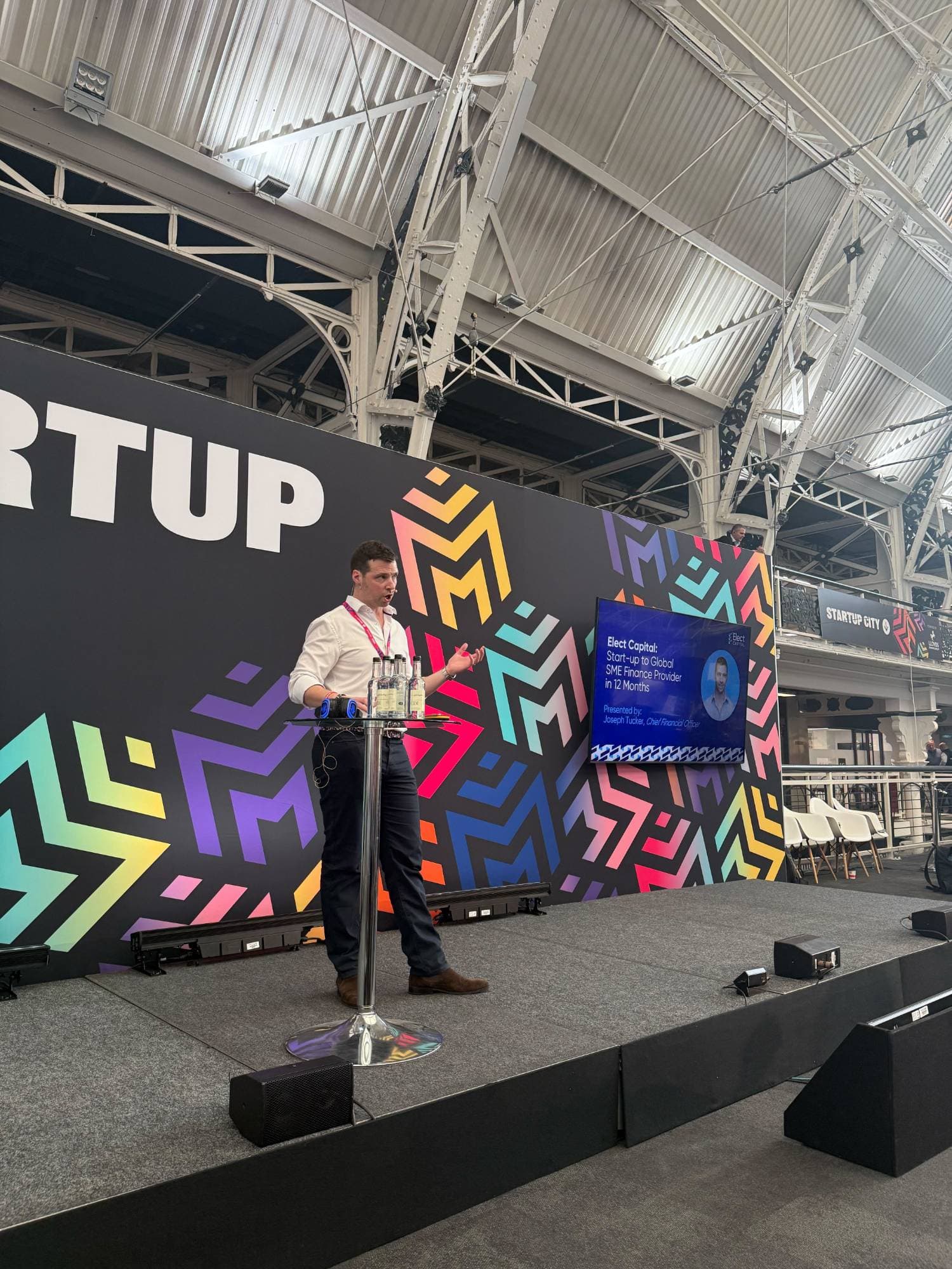 Joseph Tucker, Chief Financial Officer, presenting Elect Capital on stage at Startup Expo
